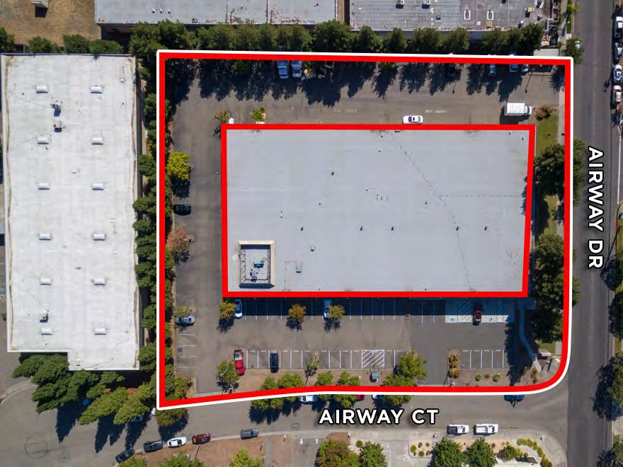 Overhead aerial with the parcel outlined between Airway Drive and Airway Court