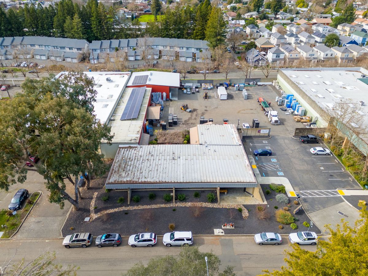 Aerial of the building front and parking
